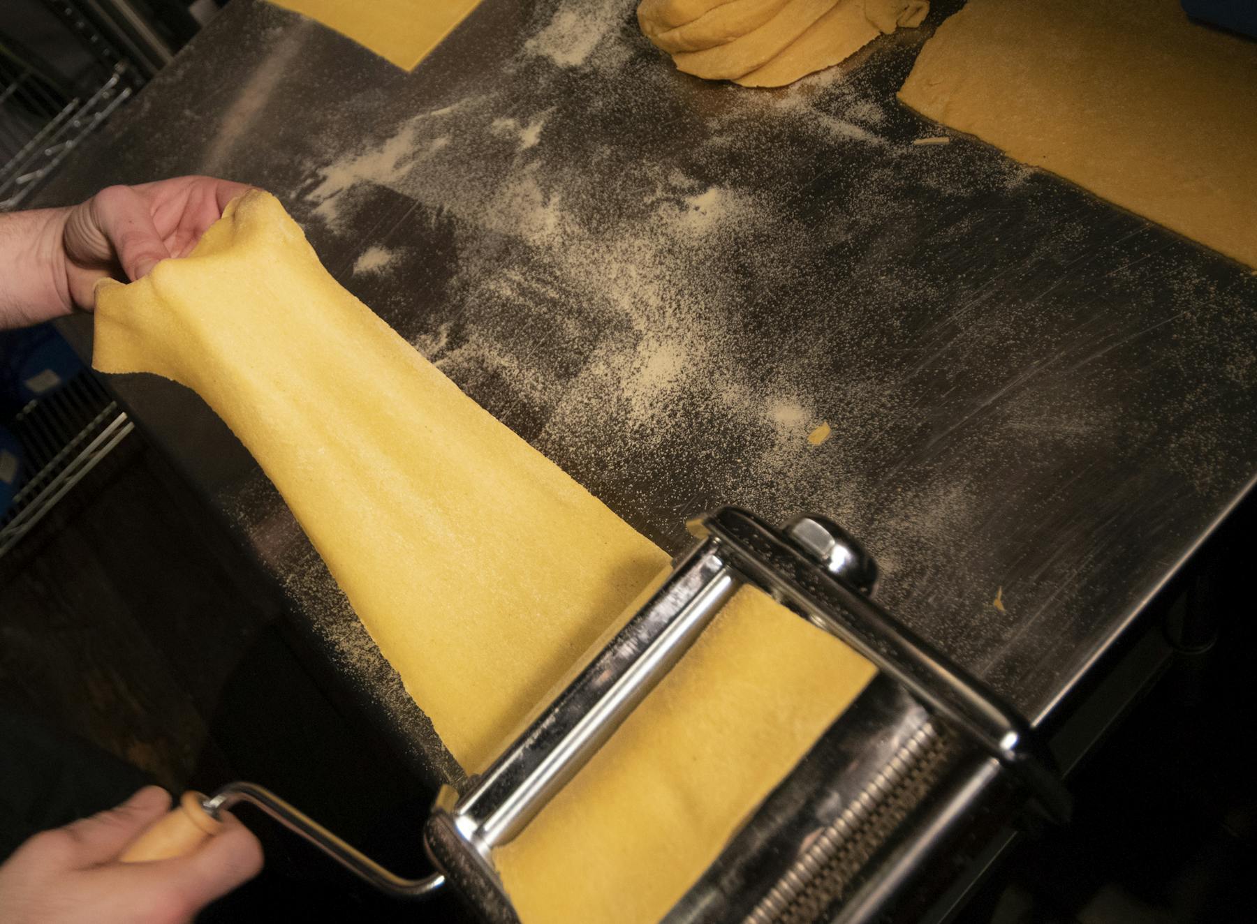a close up of a slice of pasta stretching
